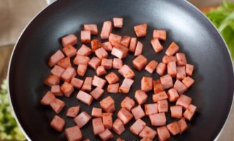 Заранее вареную колбасу порезать на кусочки и обжарить на среднем огне.