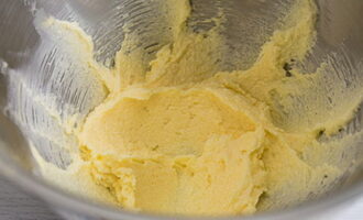 Масло взбейте с сахаром до образования кремообразной массы. Яйцо взбейте в отдельной миске, половину смешайте с молоком, вторую часть оставьте для смазывания коржиков.