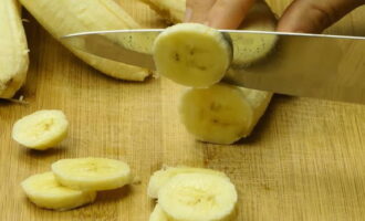 Бананы очищаем от кожуры и нарезаем кружочками толщиной 0,5 сантиметров.