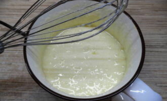 В отдельной миске соединяем яйцо, сахар, ванилин и муку. Продолжительно вымешиваем массу, пока она не станет белого цвета.