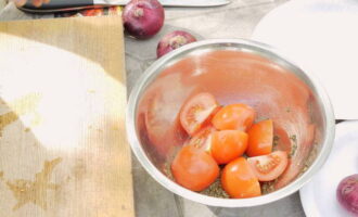 Предварительно промываем помидоры, а затем нарезаем на 4 дольки. Измельченные томаты сразу отправляем в маринад.