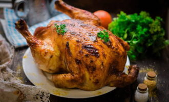 Румяная курица с сочным мясом готова. Выкладывайте ее на блюдо и подавайте к столу, украсив свежей ароматной зеленью.