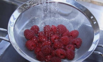 Ягоды малины перебираем. Избавляемся от гнилых и испорченных ягод. Промываем ягоды в теплой воде. Удобнее всего это сделать при помощи дуршлага. Чистые ягоды оставляем на время, чтобы лишняя жидкость стекла. 