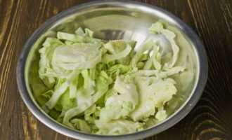 Соломкой режем белокочанную капусту. Выкладываем ингредиент в большую миску.