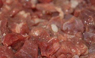 Как приготовить тушеную говядину с черносливом? Мясо помойте под проточной водой, промокните бумажными салфетками и нарежьте кубиками среднего размера.