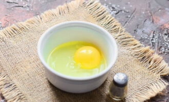 Куриное яйцо соединяем в глубокой миске вместе с солью и сахаром. Взбиваем до однородности.