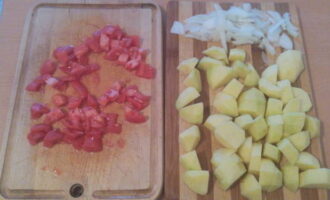 Измельчаем помидоры. Картошку очищаем и нарезаем кубиками. Можно нарезать еще немного белого репчатого лука (по желанию). Но учитывайте, что при подаче в блюде будет присутствовать еще красный лук.