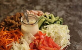 Для подачи выбираем большую плоскую тарелку. В центре размещаем небольшую баночку с соусом. Вокруг нее раскладываем горками овощи, ветчину и готовые сухарики. Перемешивать ингредиенты не нужно.