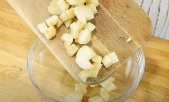 Вареный картофель остудите и очистите от кожуры. Нарежьте клубни кубиками небольшого размера. Переложите картошку в миску, добавьте к ней пару столовых ложек нерафинированного растительного масла, перемешайте.