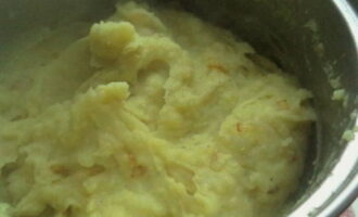 Когда картошка сварилась, сливаем воду. Делаем картофельное пюре. Приправляем половиной обжаренного лука, солью и перцем. Размешиваем до однородности.