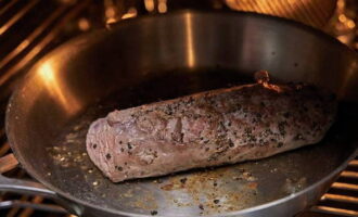 Пропитанное специями мясо, на другой сковороде, обжариваем со всех сторон до корочки, а после отправляем в духовой шкаф, прогретый до 180 градусов, на 5 минут.