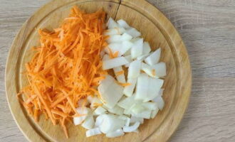 Луковую головку нарежьте кубиками, а морковку натрите на терке.