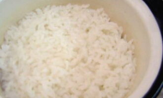 Промойте рис проточной водой. Выложите в кастрюлю, влейте воду и варите крупу в течение 10 минут.